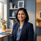 A friendly South Asian woman smiling, representing a happy customer in a professional, modern setting.