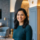 A professional portrait of a happy South Asian woman smiling, representing a satisfied customer.
